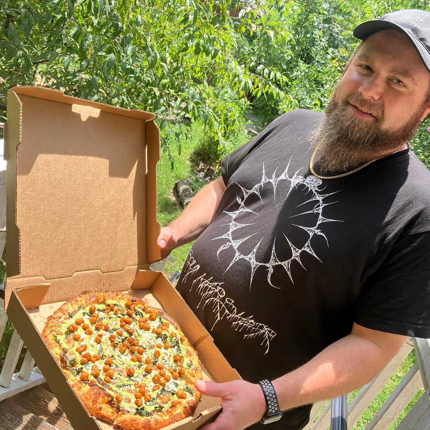 May be an image of 1 person and pizza