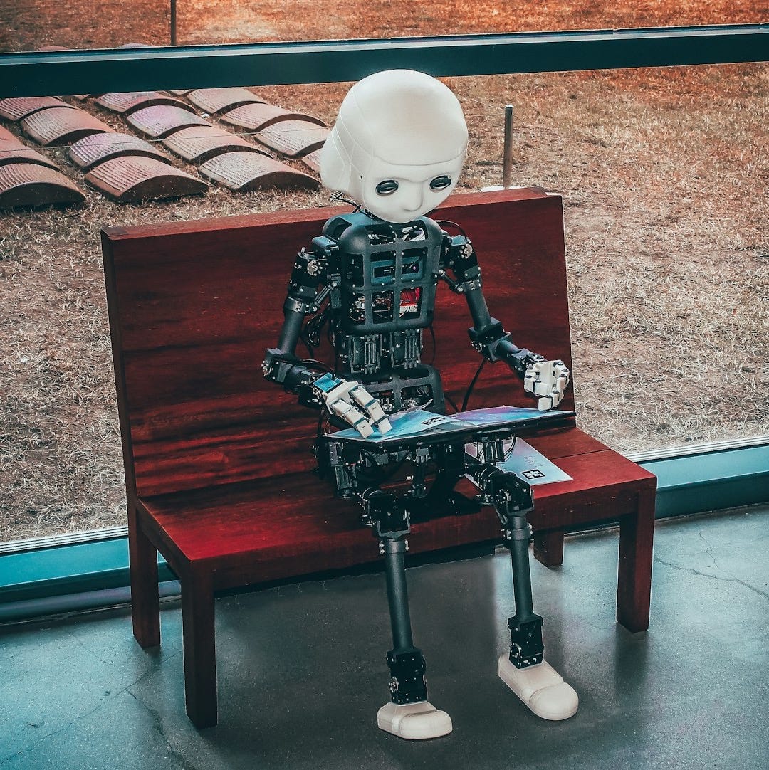 black and white robot toy on red wooden table black and white robot toy on red wooden table