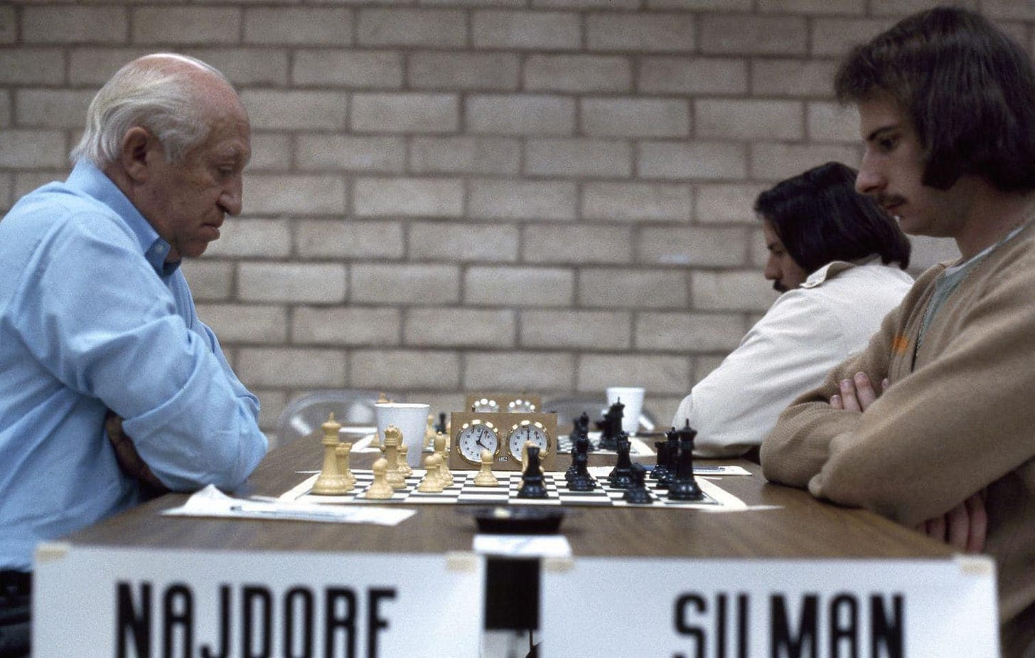 May be an image of 3 people, chess and text that says 'NA.JDORF SII MAN'