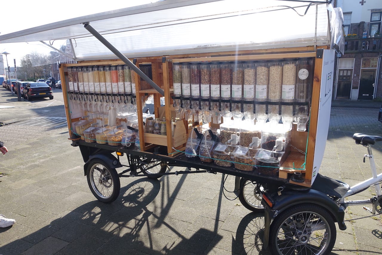 A side view of the trailer with around 20 bulk containers containing different foodstuffs
