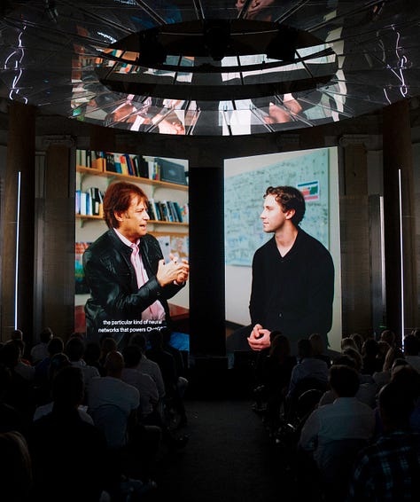 A gallery of 6 images showing close ups of the audience and zoomed out photographs of the Sana AI Summit stage.