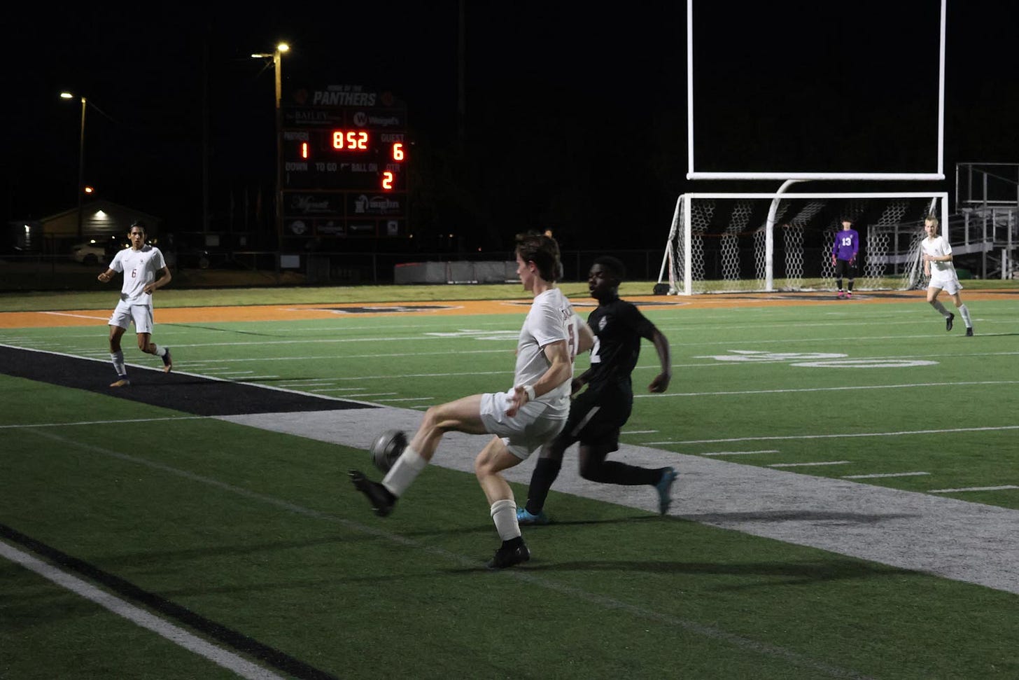 Oak Ridge and Powell boys soccer players compete for a ball.