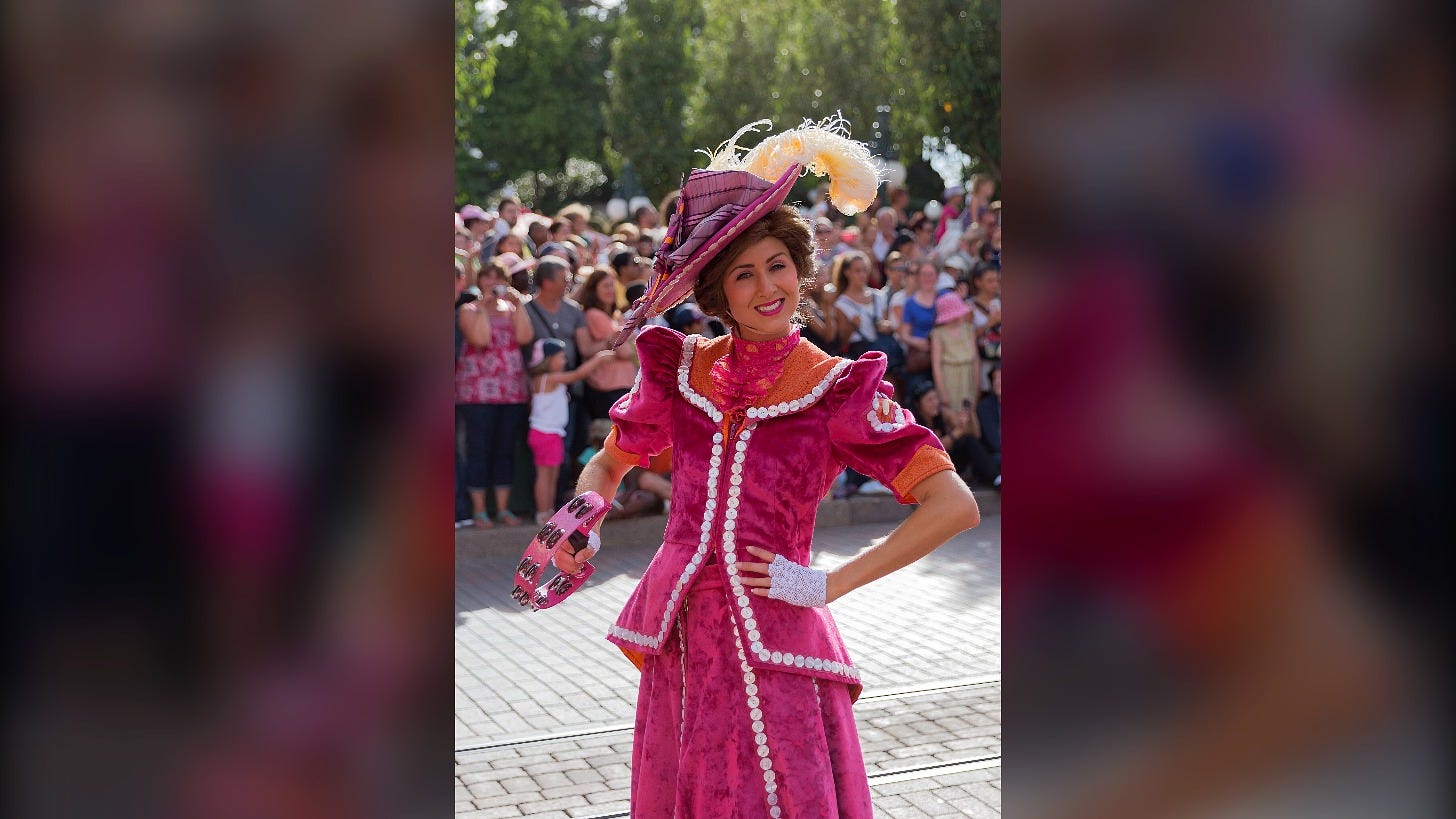 A performer from the Mary Poppins unit of Disney Magic on Parade at Disneyland Paris in 2015. The Bird Woman, from the same movie, debuted at a runDisney race Sunday. Image: William Crochot via Wikimedia Commons