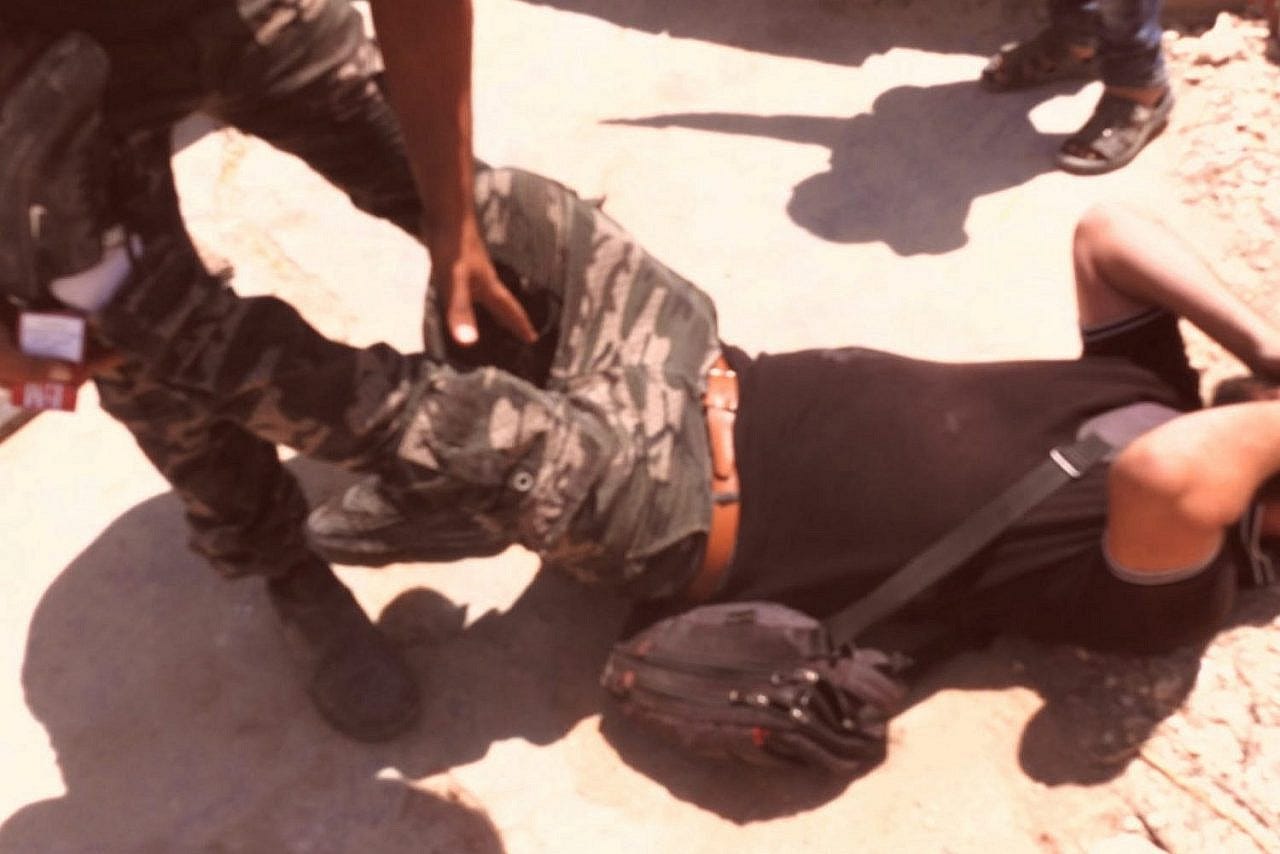 Amer al-Dababseh lies on the floor after being beaten by Israeli Border Police in his village of Khalet al-Daba, South Hebron Hills, August 11, 2021. Amer al-Dababseh lies on the floor after being beaten by Israeli Border Police in his village of Khalet al-Daba, South Hebron Hills, August 11, 2021.