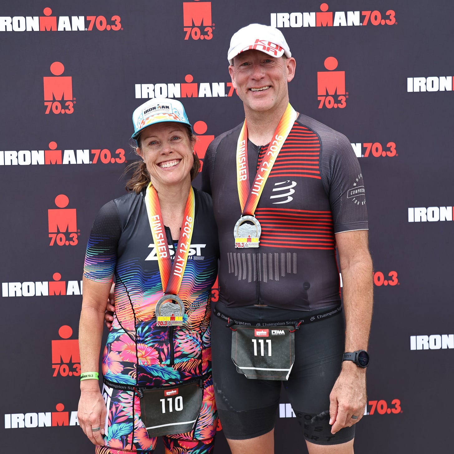 Jane and Todd Pilger after the finish of the inaugural Ruidoso 70.3 ironman triathlon with race medals.