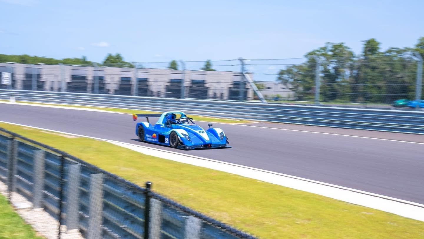 May be an image of racing vehicles, race car and text