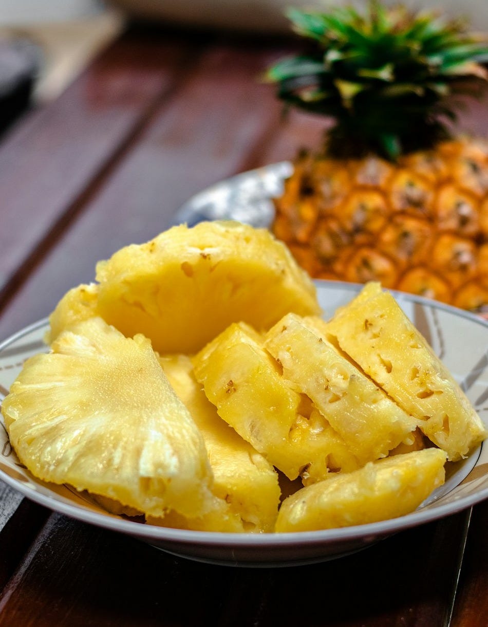 sliced pineapple on white ceramic plate sliced pineapple on white ceramic plate