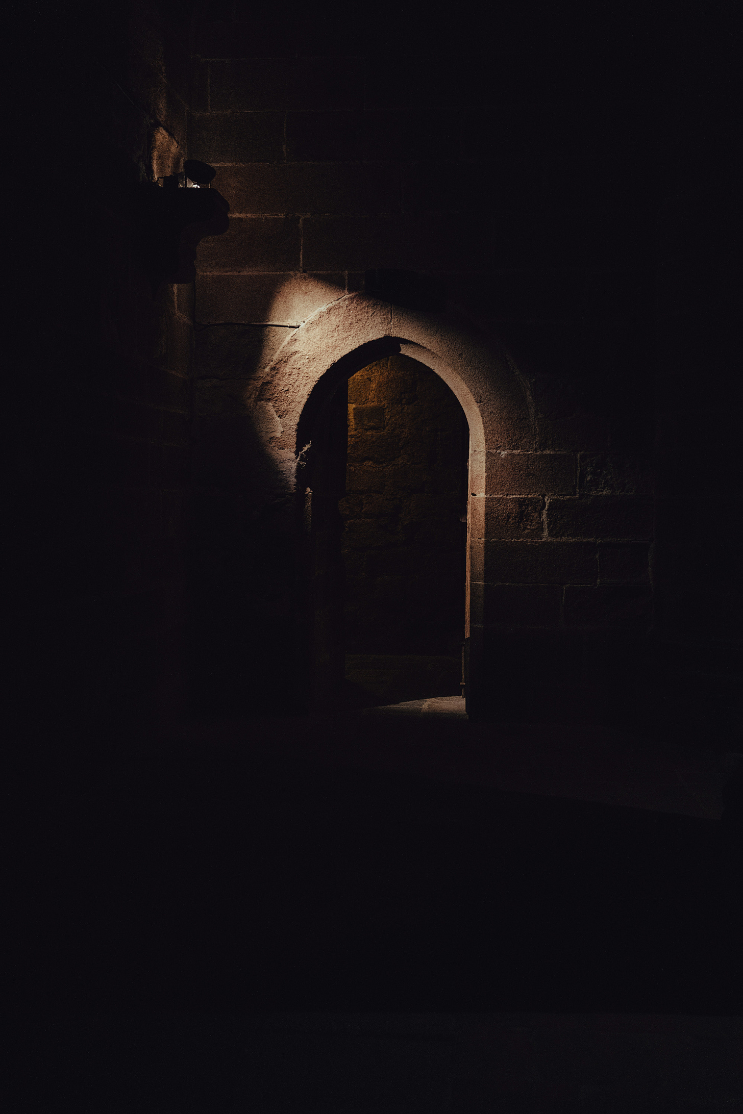 dark tunnel with door at end