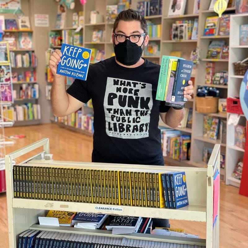 picture of Austin holding signed books