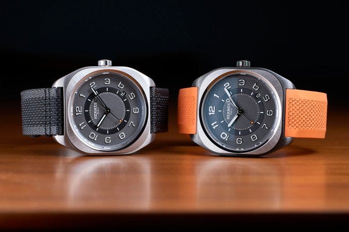 The Hermès H08 in natural titanium (left) with fabric strap, and DLC-coated titanium (right) with rubber strap. The Hermès H08 in natural titanium (left) with fabric strap, and DLC-coated titanium (right) with rubber strap.