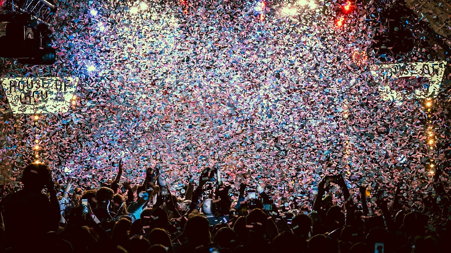 Fans celebrate under a shower of colorful confetti at a packed event, capturing the excitement of game day on a budget. Photo by Dylan Nolte on Unsplash