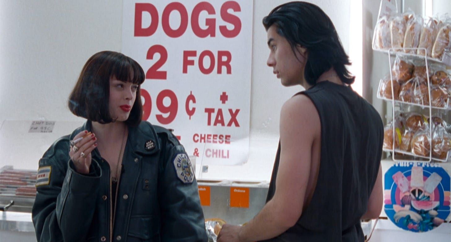 The Doom Generation | Still features Rose McGowan as Amy Blue and James Duval as Jordan White in a convenience store.