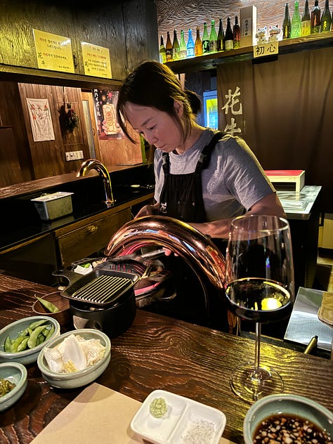 Left, image of a woman cooking over a bucket of coals. Middle, close-up of women's hands preparing food. Right, shot of the interior of a small restaurant with wood paneled walls.
