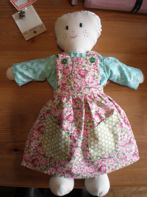 Doll in dress and pinnafore Doll in dress and pinnafore