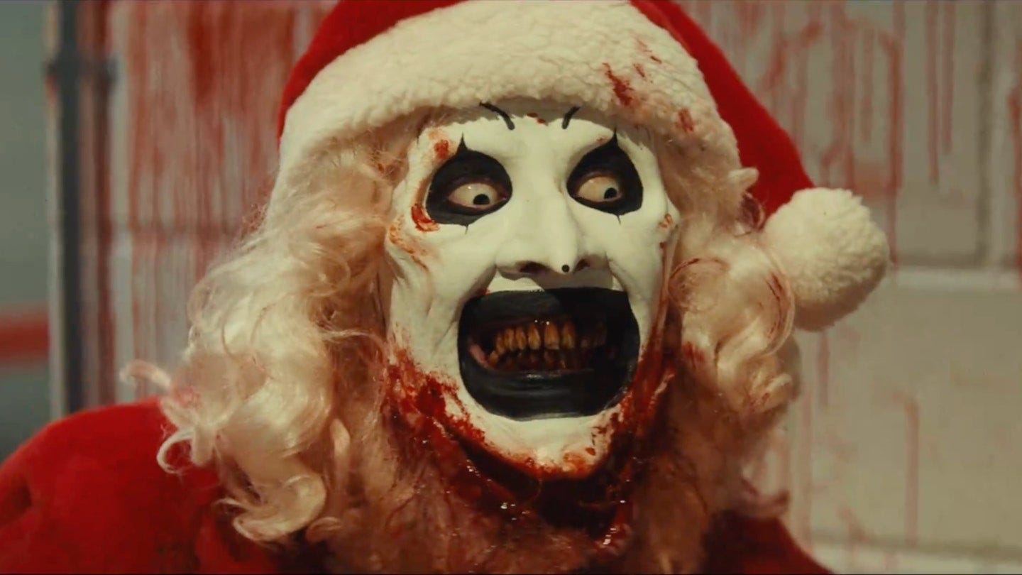 Art the Clown in a blood-stained Santa costume, blending festive cheer with slasher menace in a bizarre, off-putting holiday horror twist.