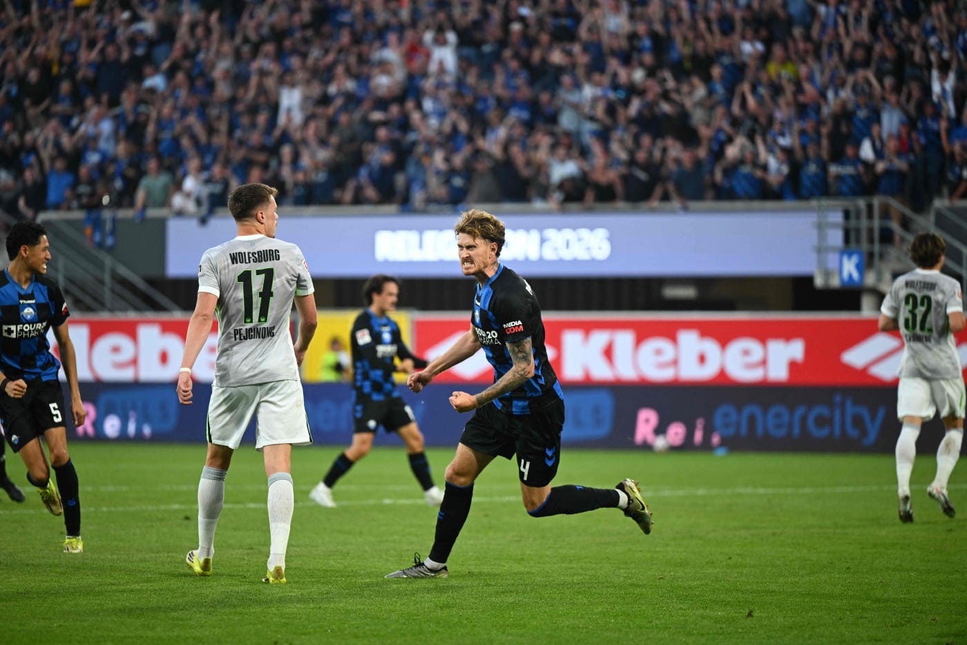 SC Paderborn's German defender #04 Calvin Brackelmann celebrates during the German Bundesliga relegation second-leg football match between SC Paderborn 07 and VfL Wolfsburg in Heidenheim. (Photo by Ina FASSBENDER / AFP)