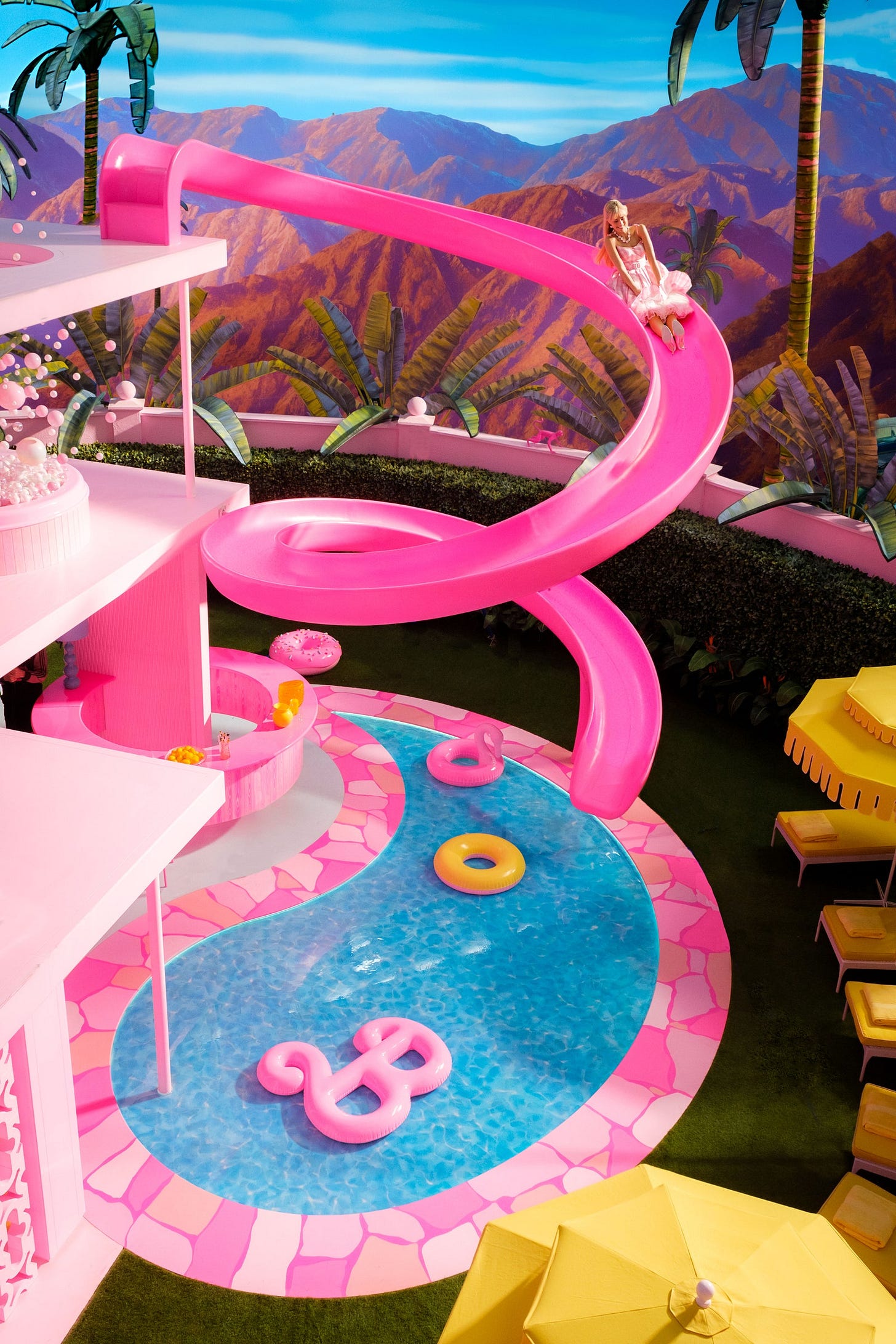The actor Margot Robbie as Barbie descending the slide of the lifesize Dreamhouse that was erected at Warner Bros....