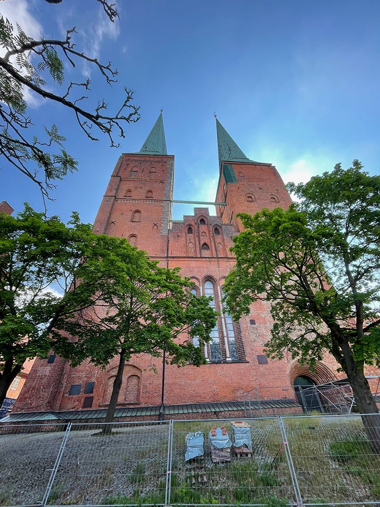 Photograph of Lübeck’s cathedral, with wire fencing and pallets of bricks