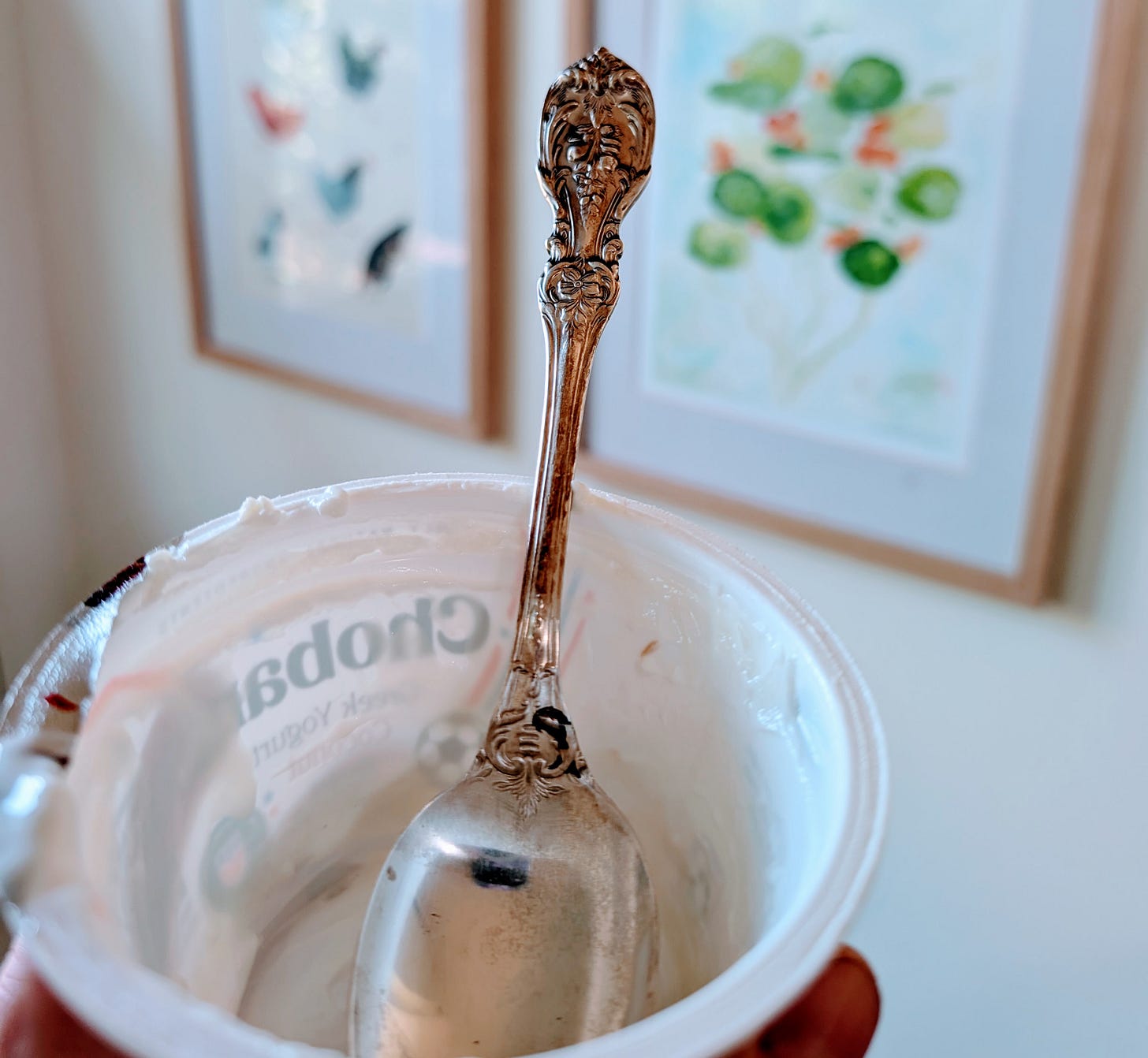 A silver spoon in an empty yogurt cup A silver spoon in an empty yogurt cup