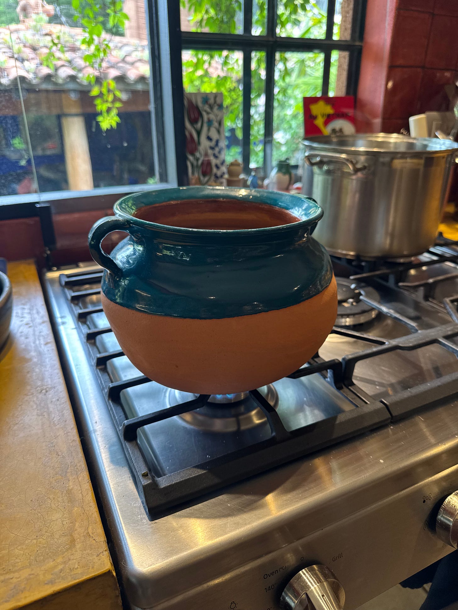 A clay pot on a stove.