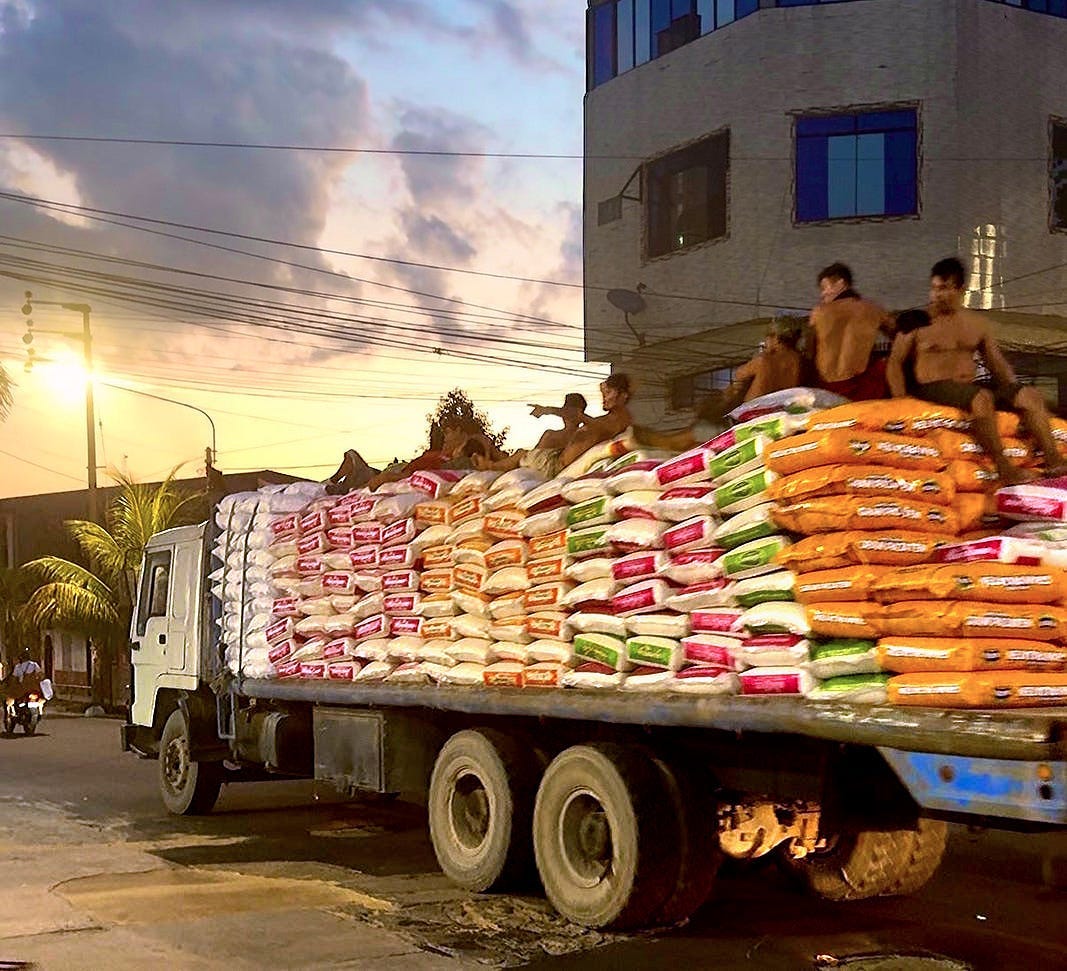 Photo of men atop truck in Iquitos, Peru