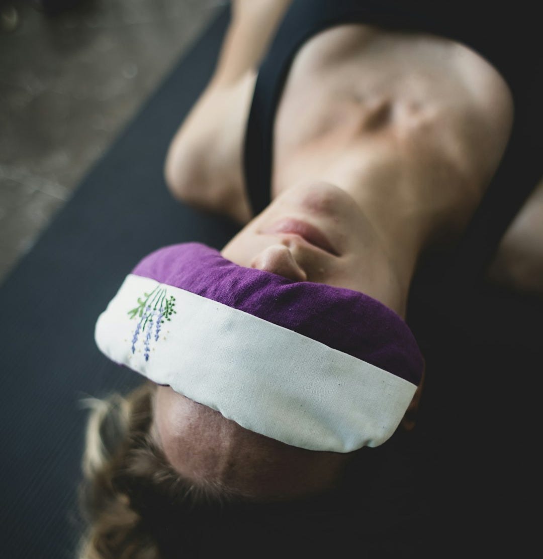 woman put purple and white pad on her forehead woman put purple and white pad on her forehead