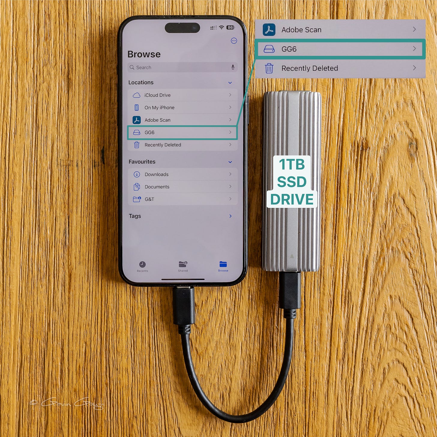 iPhone with SDD drive attached, ready to receive files.
