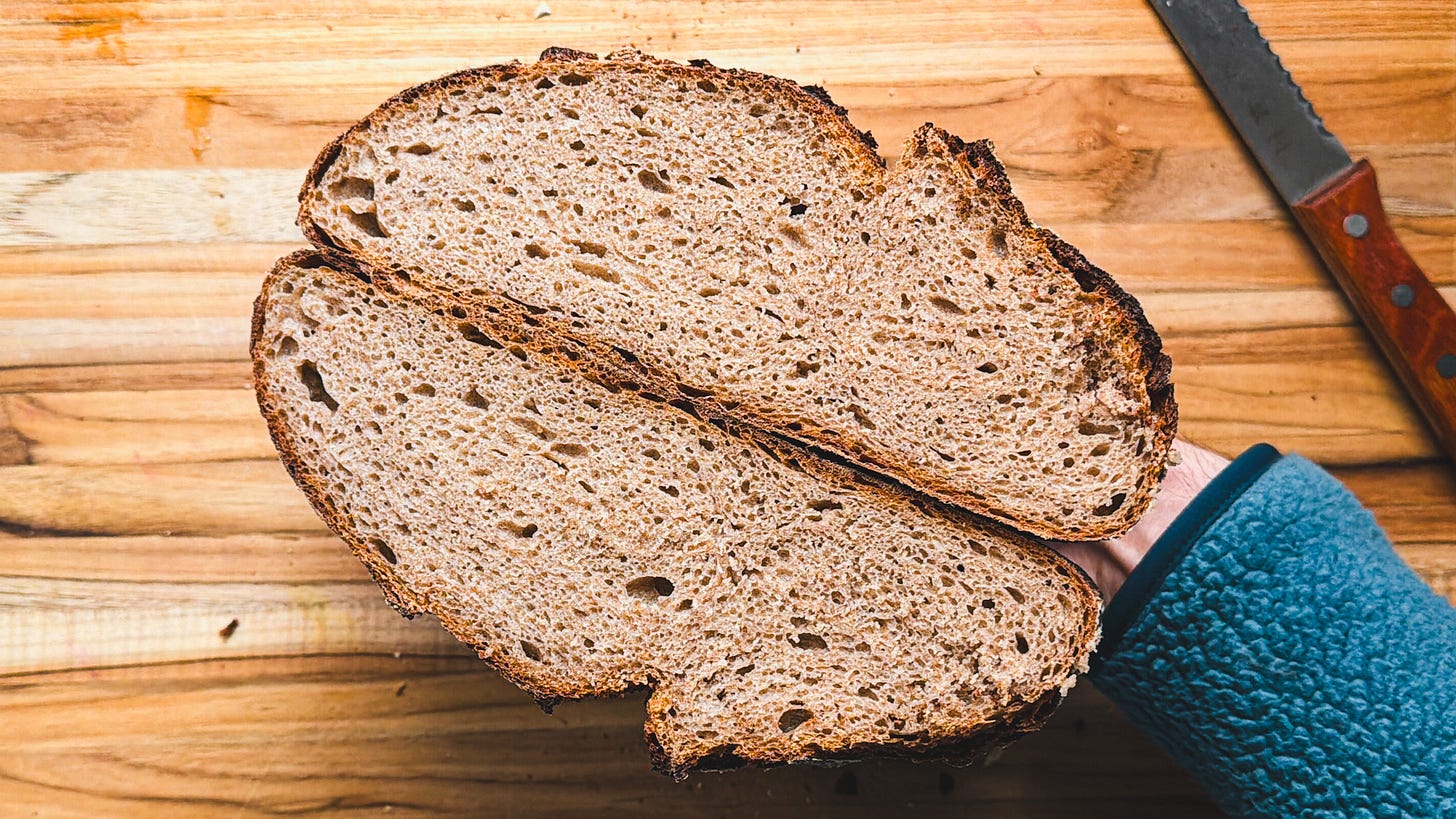 A loaf of bread sliced through the middle, looking at the crumb. A loaf of bread sliced through the middle, looking at the crumb.