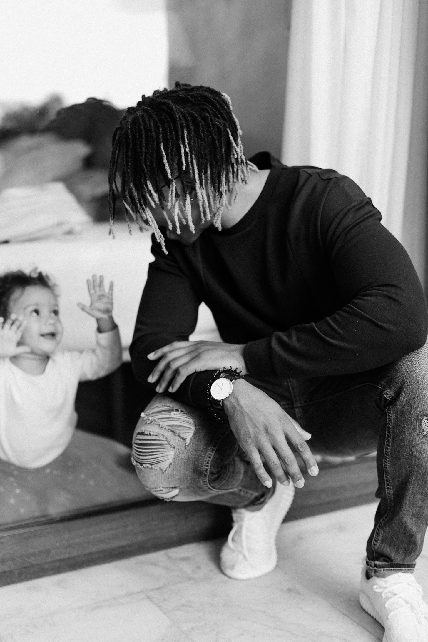 father interacting with toddler