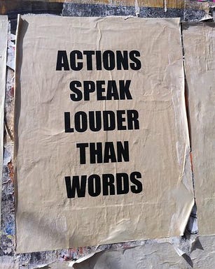 Photo of a poster that says Actions speak louder than words