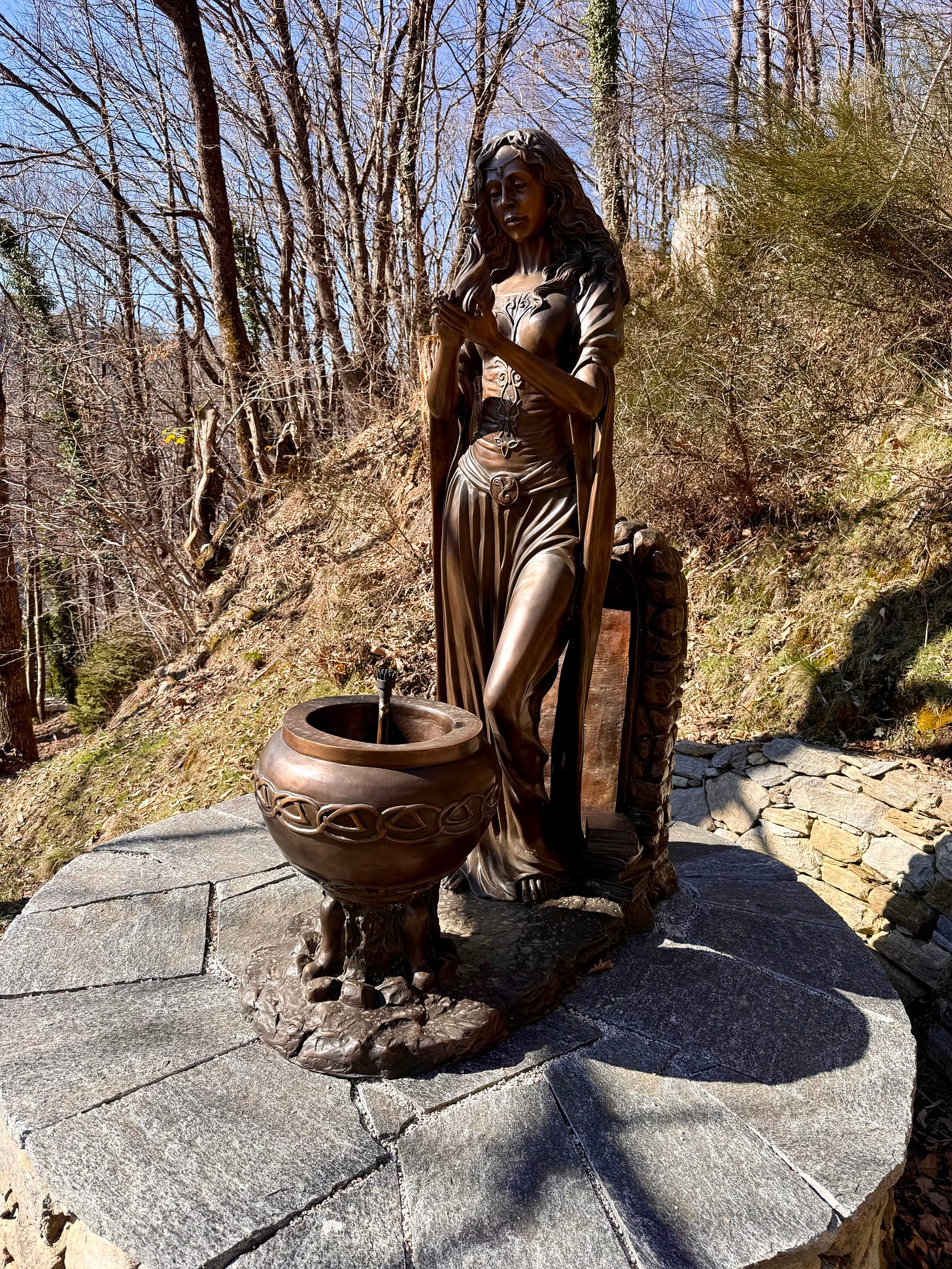 Bronze statue of Brigid - goddess standing with flames and flowing robes Bronze statue of Brigid - goddess standing with flames and flowing robes