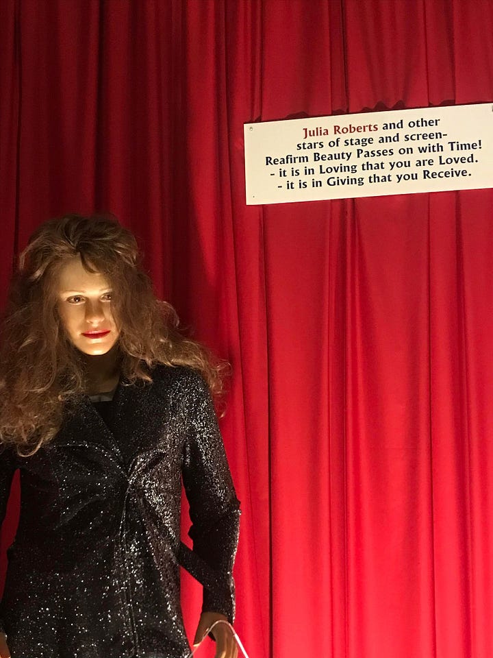 Two images, one of a Princess Diana wax work where she is dressed in white with a hat and looks nothing like the actual Princess Di. The other is of Julia Roberts, it isslightly more true to life but the statue is wearing a very matted wig.