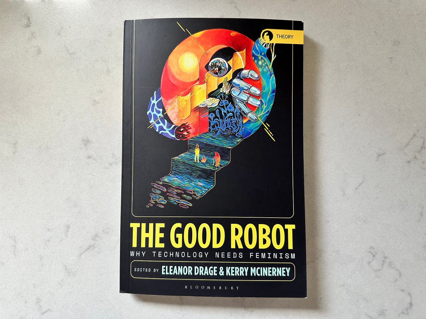 Picture of a book titled "The Good Robot", edited by Eleanor Drage and Kerry McInerney, on a white marble table. The cover has a futuristic, abstract artwork by illustrator Sinjin Li showing three figures climbing a styled staircase towards fiery red and blue sphere. Picture of a book titled "The Good Robot", edited by Eleanor Drage and Kerry McInerney, on a white marble table. The cover has a futuristic, abstract artwork by illustrator Sinjin Li showing three figures climbing a styled staircase towards fiery red and blue sphere.