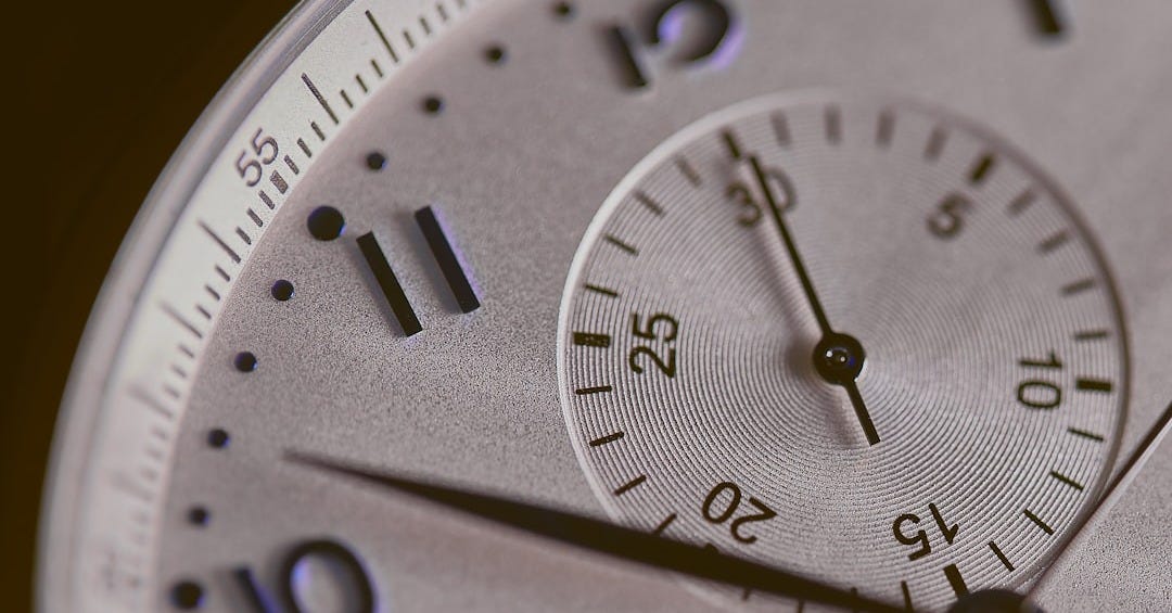 a close up of a silver watch face