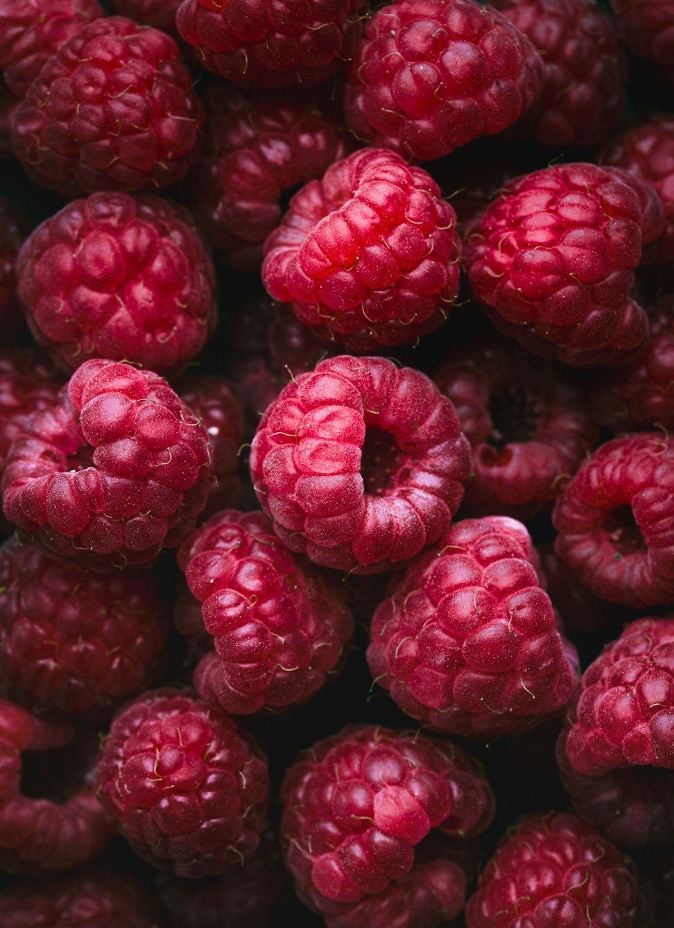 a bunch of raspberries sitting on top of each other