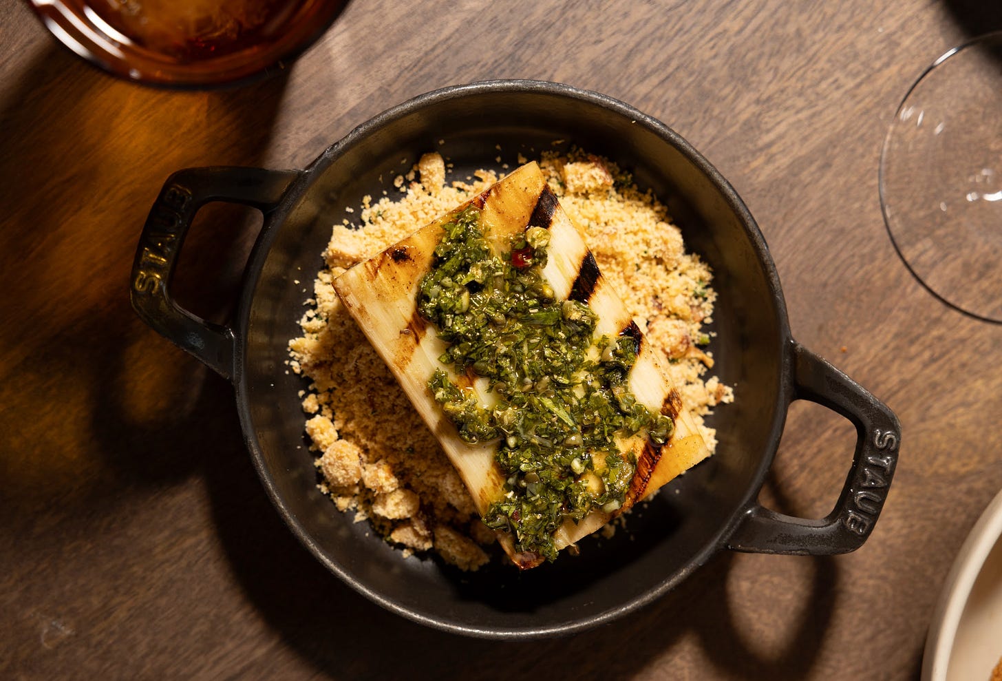 A cast-iron skillet with a slab of a pale vegetable..