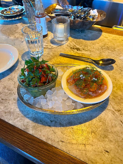 Photo of a crudo, nicoise salad, and chopped cheese sandwich