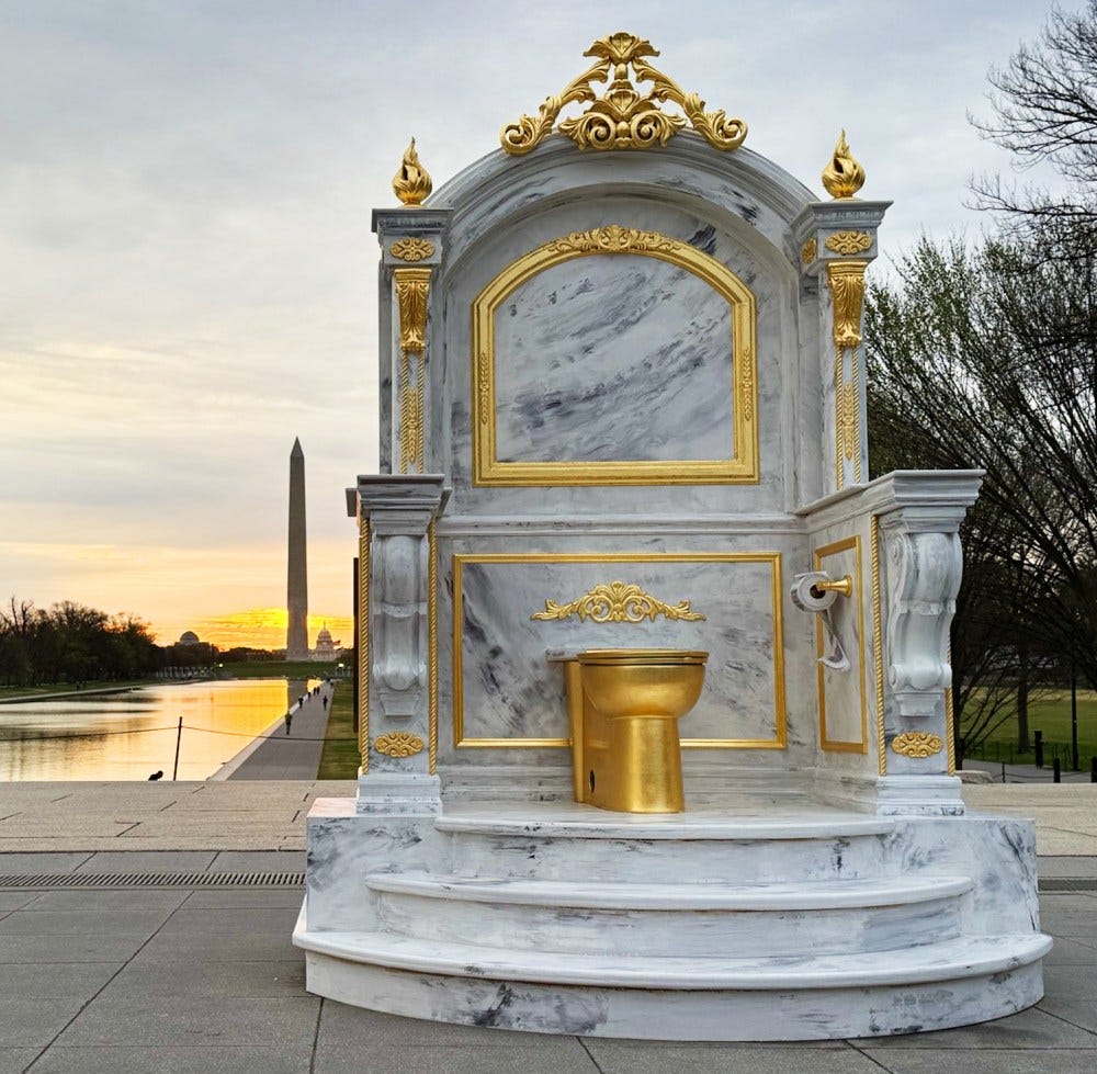 A sculpture placed on the National Mall in Washington, DC shows a gold commode in a marble niche with the Washington Monument in the distant background. A sculpture placed on the National Mall in Washington, DC shows a gold commode in a marble niche with the Washington Monument in the distant background.