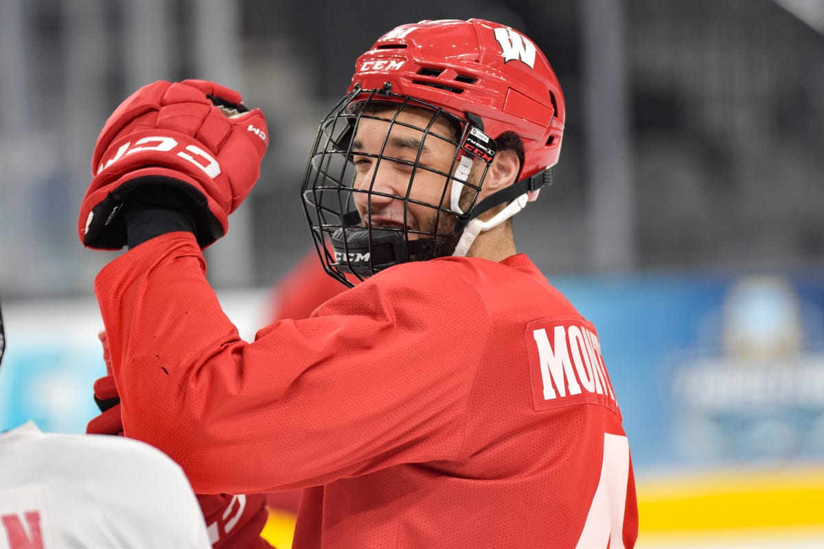 Blake Montgomery smiling. Red ccm helmet with black facemark