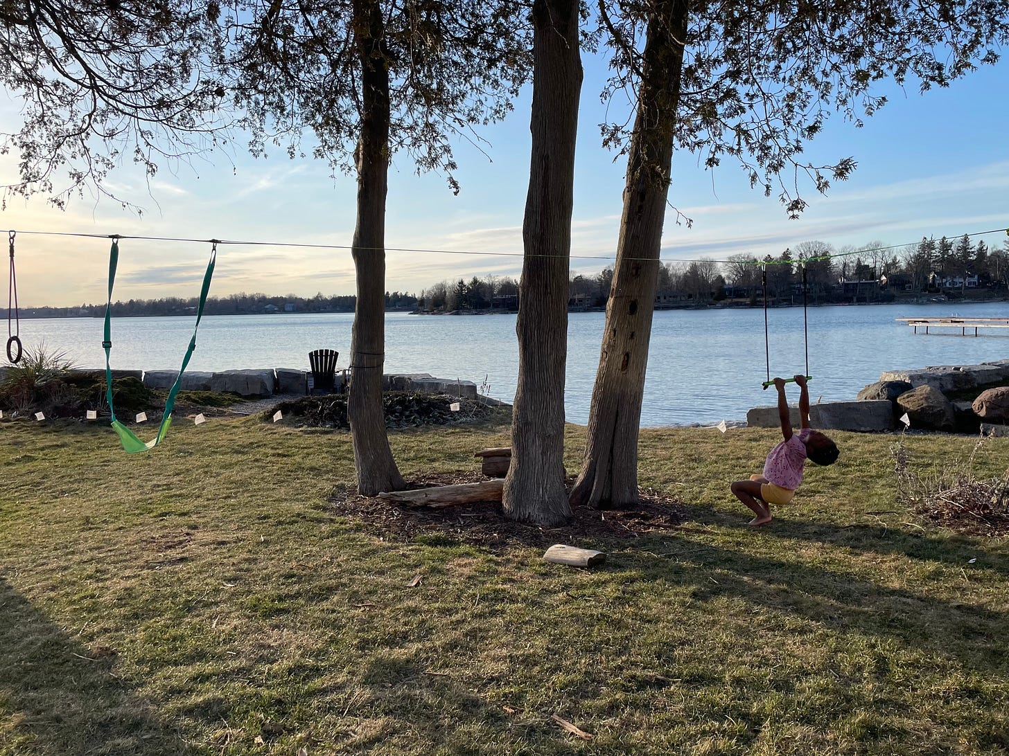 a kid swinging in a t shirt and shorts