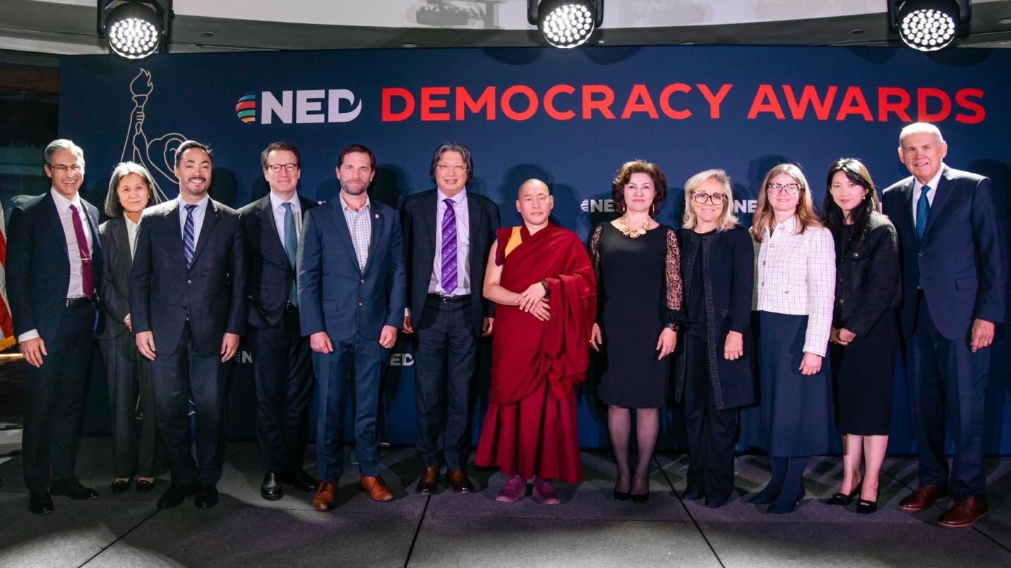 A group of people standing in front of a banner

AI-generated content may be incorrect.