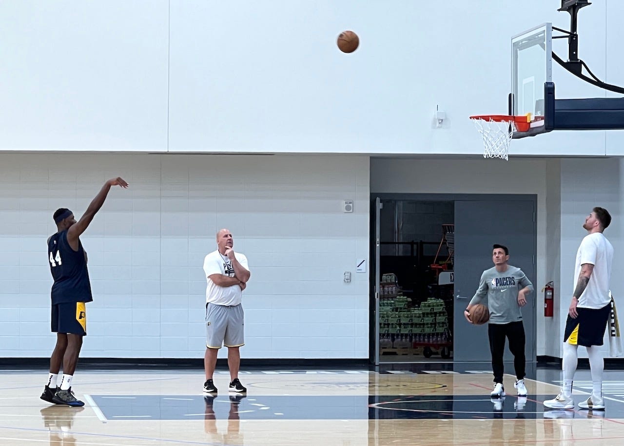 Jim Boylen works with Kentucky's Oscar Tshiebwe during summer league practice.