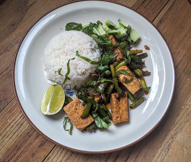 a plate of pad prik khing stir fry tofu and asparagus