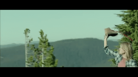 Reese Witherspoon throwing her boot off a cliff in Wild