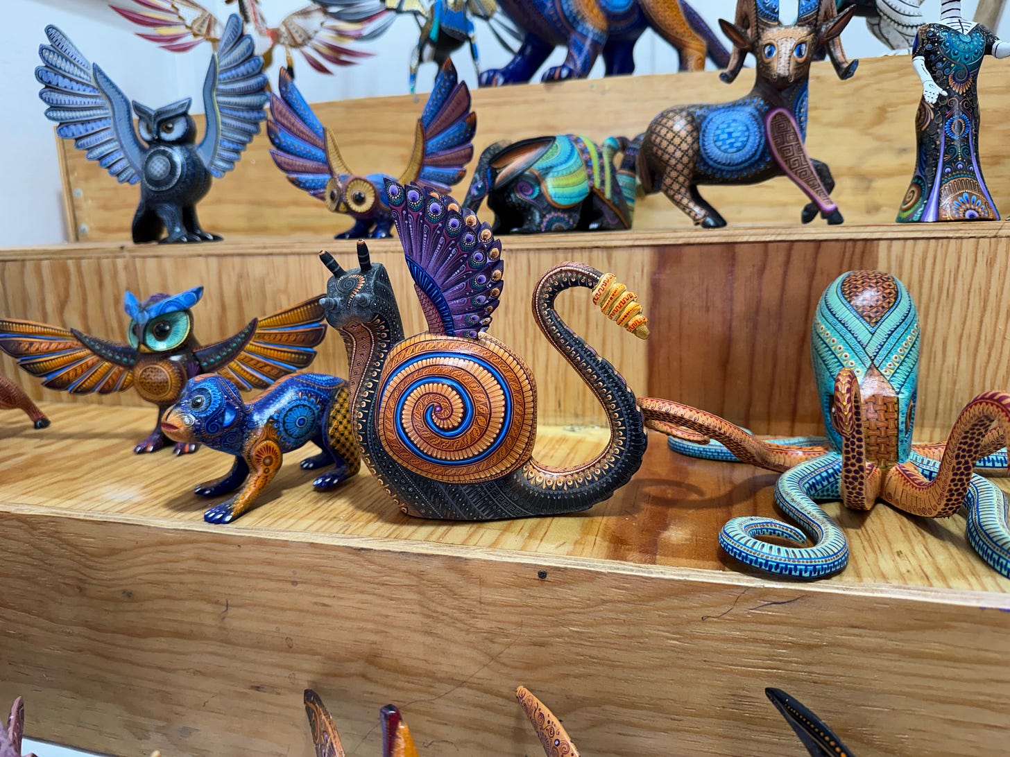 A shelf full of alebrijes.