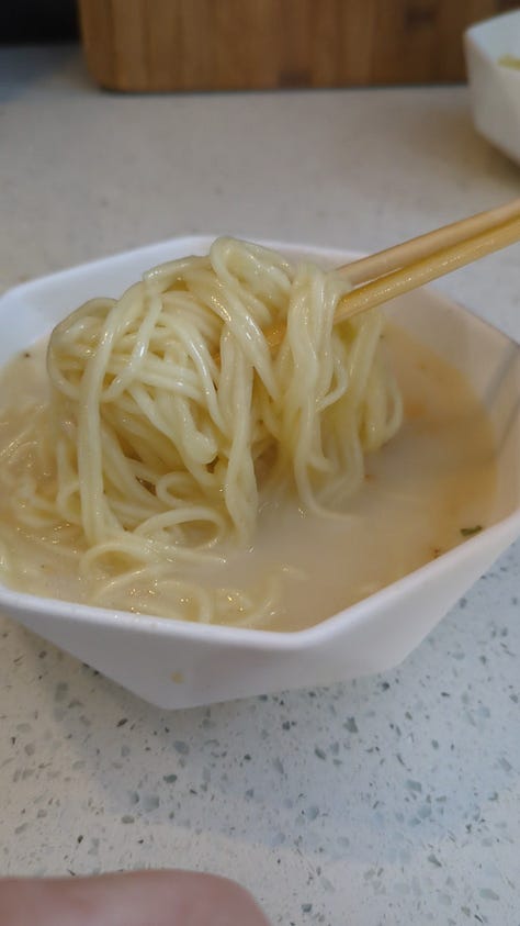 Nissin Raoh instant ramen packet being opened, noodles cooked, sauce packets mixed, and final product served in a delicious soupy bowl.