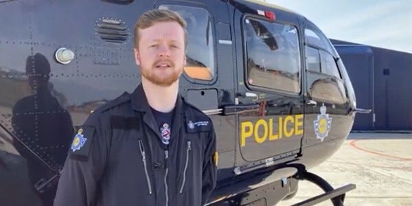PC Sam Sarfas next to a National Police Air Support helicopter