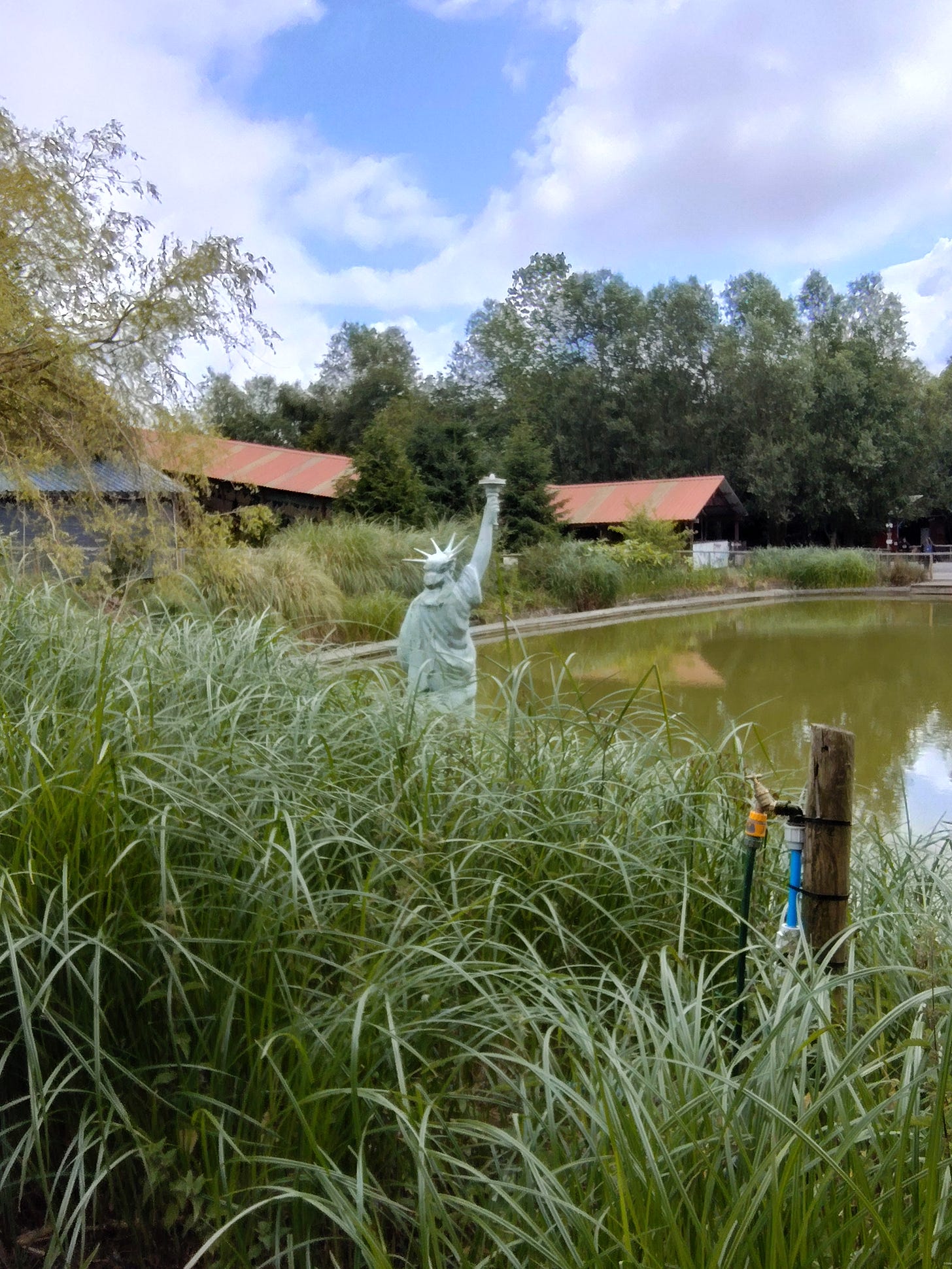 Small scale Statue of Liberty overlooking a pond