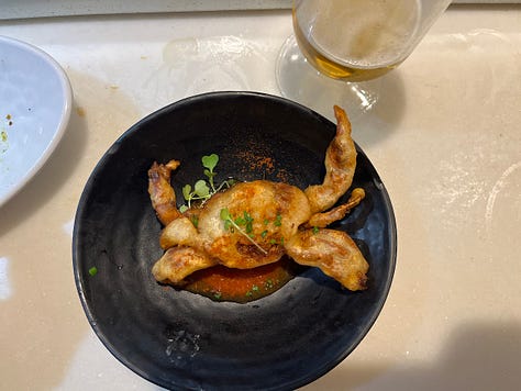 A single scallop with bread crumbs and puffed rice crips, a whole battered and fried crab, a cute up beef cheek with mashed and fried potatoes