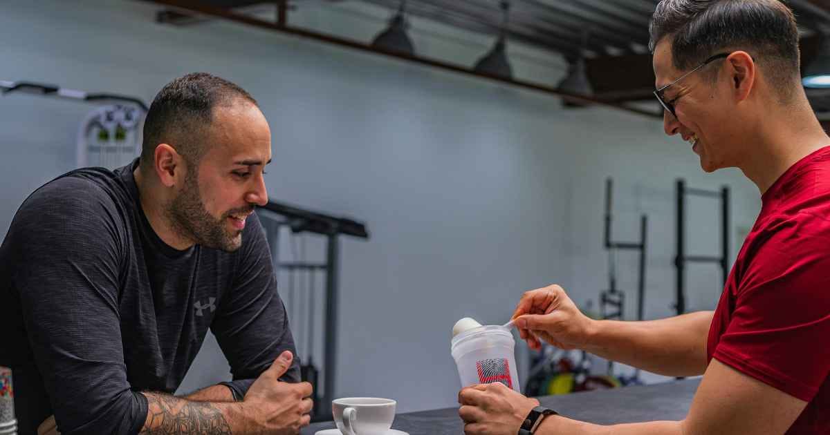 man at the gym preparing a protein shake